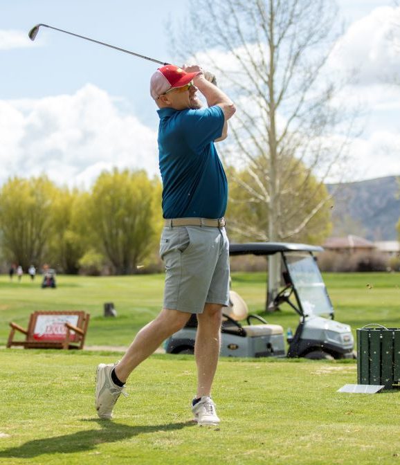 golfer teeing off at 2023 Living Journeys Golf Tournament